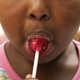 child eating lollipop